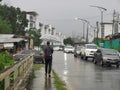 Outdoor scenery during raining season with traffic jam at apartment road.