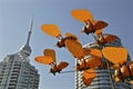 Outdoor sculpture of bees with the urban city background