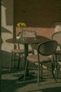 Outdoor seating area with chairs and a matching table next to a brick wall. Royalty Free Stock Photo