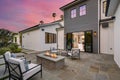 Outdoor seating area with a fire pit and chairs during sunset. Royalty Free Stock Photo