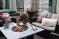 Outdoor seating arrangement around a gas fire pit table in the fall Royalty Free Stock Photo