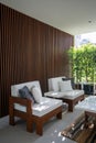 Outdoor seating corner with wood batten background in tree shade /interior design / outdoor space / copy space