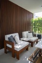 Outdoor seating corner with wood batten background in tree shade /interior design / outdoor space / copy space