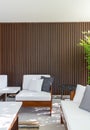 Outdoor seating corner with wood batten background in tree shade  /interior design / outdoor space / copy space Royalty Free Stock Photo