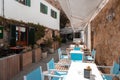 Outdoor seating of mediterranean restaurant. El fresco dining with empty chairs Royalty Free Stock Photo