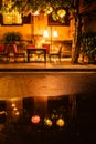 Outdoor seating at a restaurant with orange glow of street lights Royalty Free Stock Photo