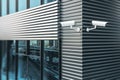 Outdoor security concept with white CCTV camera set on the corner of modern building