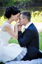 Outdoor sensual portrait of young beautiful couple in love posing in summer park boyfriend kissing his girlfriend Royalty Free Stock Photo