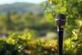 Outdoor serenade Microphone stands amidst nature, echoing music and awareness