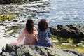 Beautiful young women posing on a rocky beach Royalty Free Stock Photo