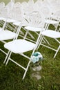 Outdoor setting with several chairs arranged in a circle, with a decorative vase of flowers