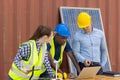 Outdoor shot of black African engineer inspect electrical solar panel wearing hardhat, protective eyeglass and safety equipment