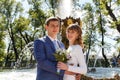 Outdoor shot of bride and groom standing near fountain in park Royalty Free Stock Photo