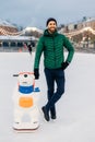 Outdoor shot of glad bearded male wears green jacket and hat, st