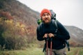 Outdoor shot of handsome Caucasian hiker young man hiking in mountains with travel backpack. Royalty Free Stock Photo