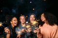 Outdoor shot of laughing friends with sparklers