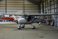 Outdoor shot of small plane standing in shed Royalty Free Stock Photo