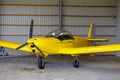 Outdoor shot of small plane standing in shed Royalty Free Stock Photo