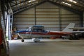Outdoor shot of small plane standing in shed Royalty Free Stock Photo