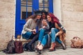 Outdoor shot of three young women looking at smartphone and laughing on city street. Girls talking and having fun Royalty Free Stock Photo