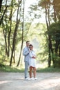 Outdoor shot of young happy couple in love on sunny day on nature. Man and woman hugging, sunlight in summer park. valentine`s da Royalty Free Stock Photo