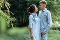 Outdoor shot of young happy couple in love on sunny day on nature. Man and woman hugging, sunlight in summer park. valentine`s da Royalty Free Stock Photo