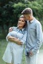 Outdoor shot of young happy couple in love on sunny day on nature. Man and woman hugging, sunlight in summer park. valentine`s da Royalty Free Stock Photo