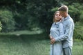 Outdoor shot of young happy couple in love on sunny day on nature. Man and woman hugging, sunlight in summer park. valentine`s da Royalty Free Stock Photo