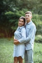 Outdoor shot of young happy couple in love on sunny day on nature. Man and woman hugging, sunlight in summer park. valentine`s da Royalty Free Stock Photo