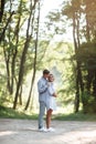 Outdoor shot of young happy couple in love on sunny day on nature. Man and woman hugging, sunlight in summer park. valentine`s da Royalty Free Stock Photo