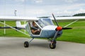 Outdoor shot of young man in small plane cockpit Royalty Free Stock Photo