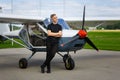 Outdoor shot of young man in small plane cockpit Royalty Free Stock Photo