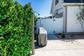 An outdoor shower near a backyard fenced swimming pool Royalty Free Stock Photo