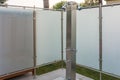 Public stainless steel shower by a pool