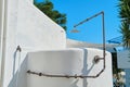 Outdoor shower, white stone shower, blue sky