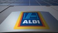 Outdoor signage board with Aldi logo. Modern office building. Editorial 3D rendering