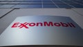 Outdoor signage board with ExxonMobil logo. Modern office building. Editorial 3D rendering