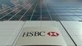 Signage board with HSBC logo. Modern office building facade time lapse. Editorial 3D rendering