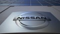 Outdoor signage board with Nissan logo. Modern office building. Editorial 3D rendering