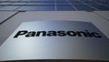 Outdoor signage board with Panasonic Corporation logo. Modern office building. Editorial 3D rendering