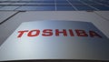 Outdoor signage board with Toshiba Corporation logo. Modern office building. Editorial 3D rendering