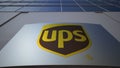 Outdoor signage board with United Parcel Service UPS logo. Modern office building. Editorial 3D rendering Royalty Free Stock Photo