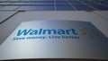 Outdoor signage board with Walmart logo. Modern office building. Editorial 3D rendering