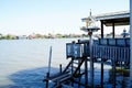 Outdoor spirit house on riverside local terrace in Thailand with garland and flowers in vases and some wreathes, joss house