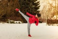 Woman wearing sportswear training boxing outside