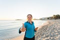 Outdoor sport, fitness gadget and people concept - Smiling female fitness show thumbs up and holding smartphone with