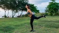 A young woman is engaged in stretching her legs by the sea Royalty Free Stock Photo