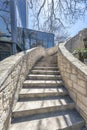 Outdoor staircase with sunlit concrete steps and stone railings on a sunny day Royalty Free Stock Photo