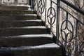 An outdoor stairway with an iron railing in winter