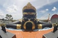 Outdoor statue of Phra Rahu suck the moon at Wat Sra Long Ruea temple.